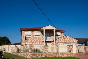 double storey brick home with blockout roller shutters seen from outside